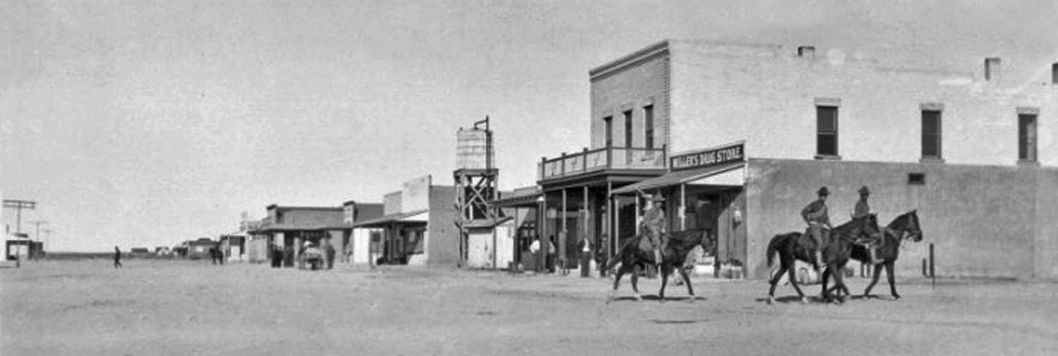 U.S. Cavalry Riding by Miller's Drug Store - Columbus, New Mexico - 1916
